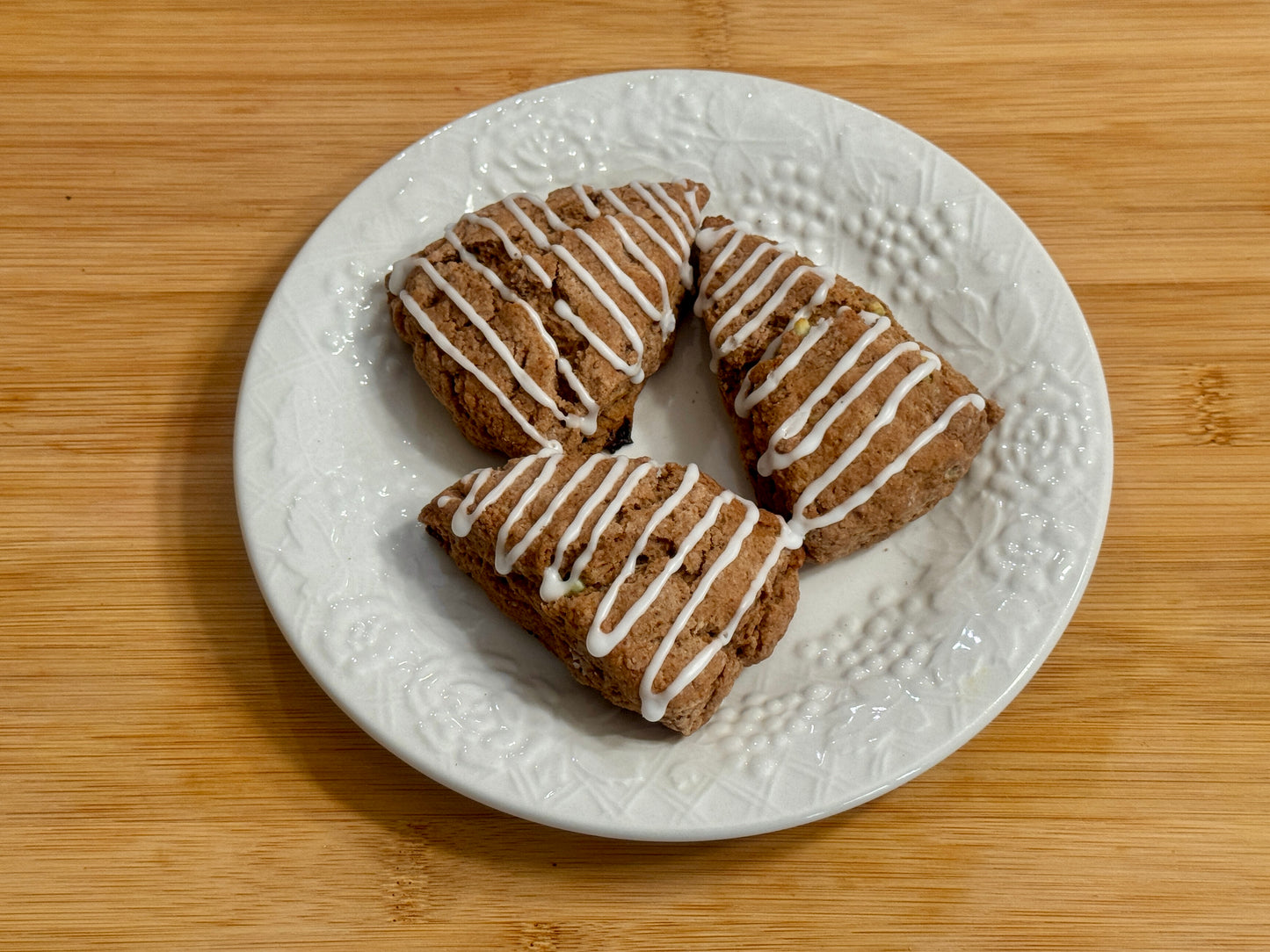 three mini peppermint mocha scones with mint icing on a decorative plate