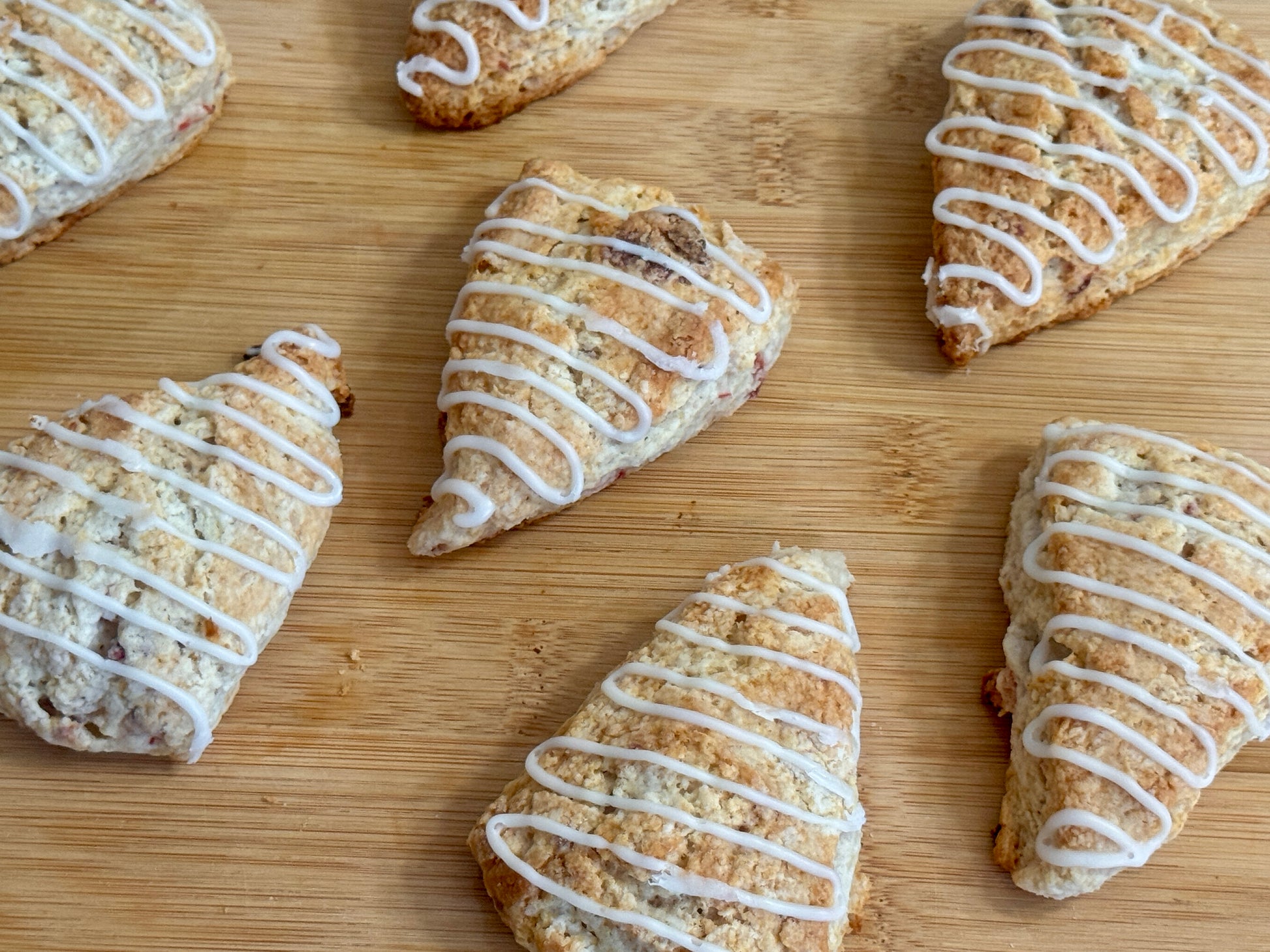 Glazed mini strawberry scones on a wooden board